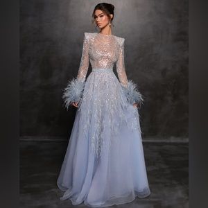 Designer Fjolla Nila, Dora Dress in light blue with feather details.